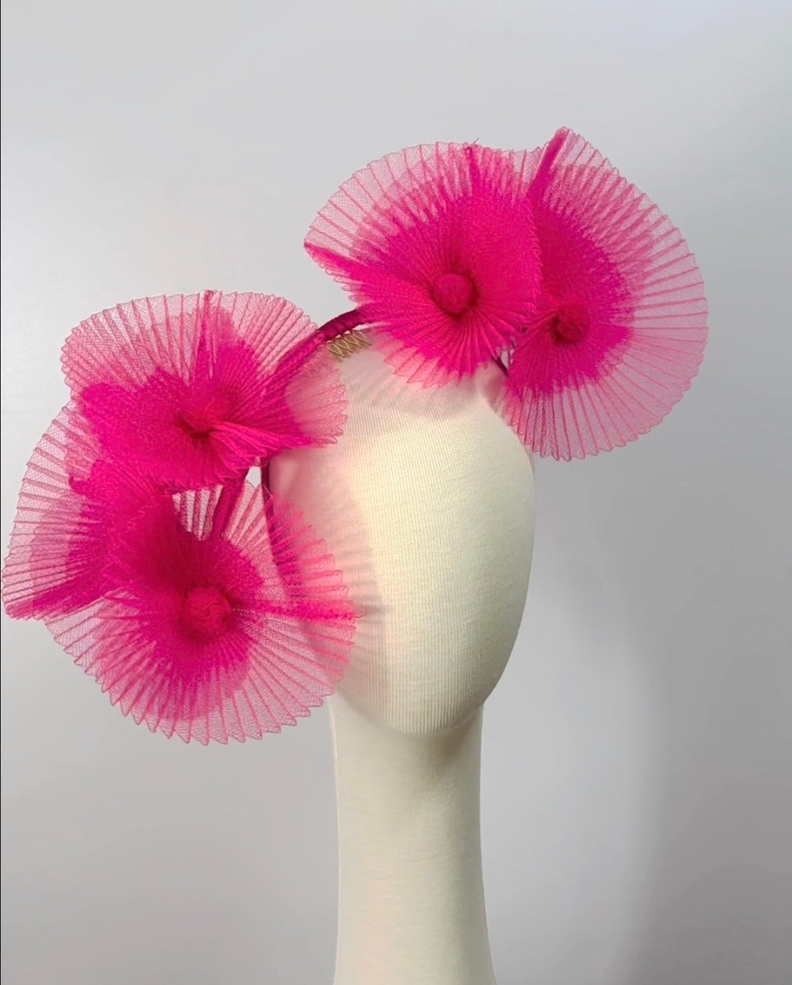 Pink sculptured headpiece by Possum Ball